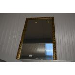 A gilt framed modern wall mirror