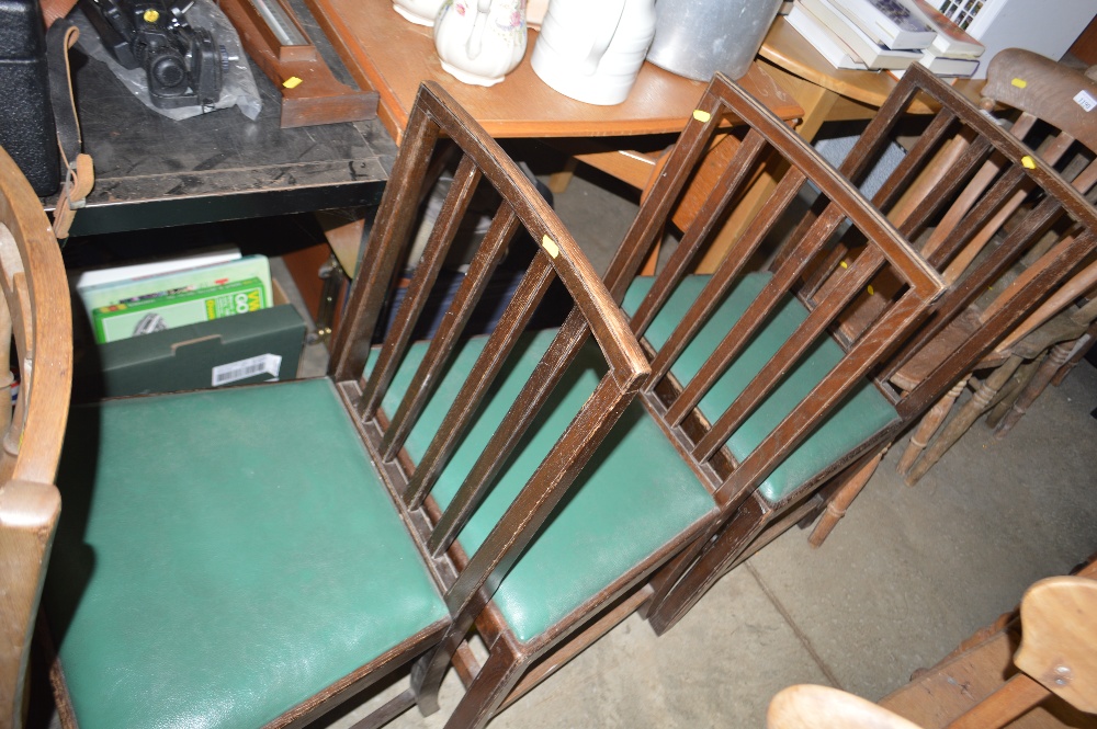 Three oak rail back chairs designed by Edward Barns