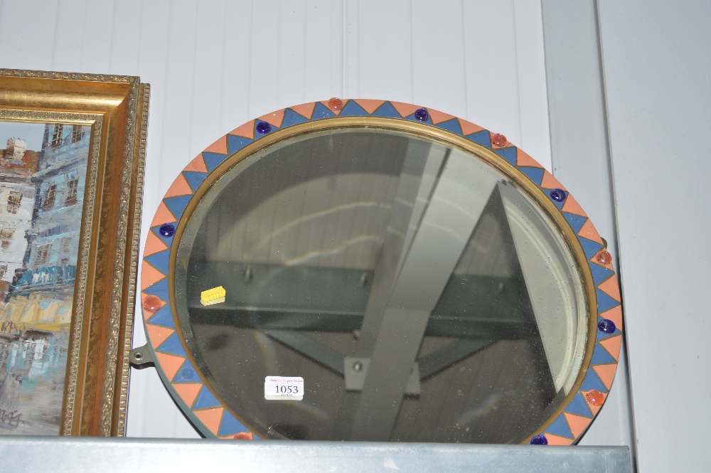 A circular bevel edged wall mirror