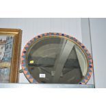 A circular bevel edged wall mirror