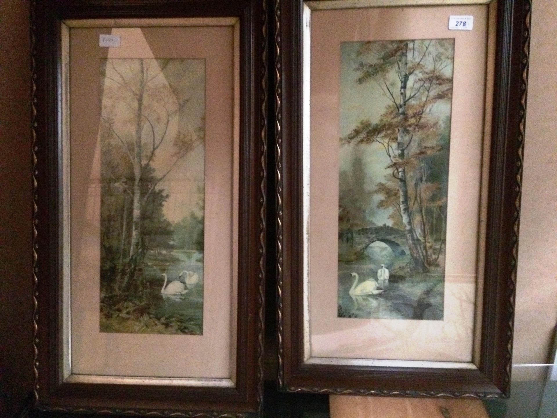 A pair of ornate wood finish framed prints - Swans in a woodland setting each 48 x 20cm