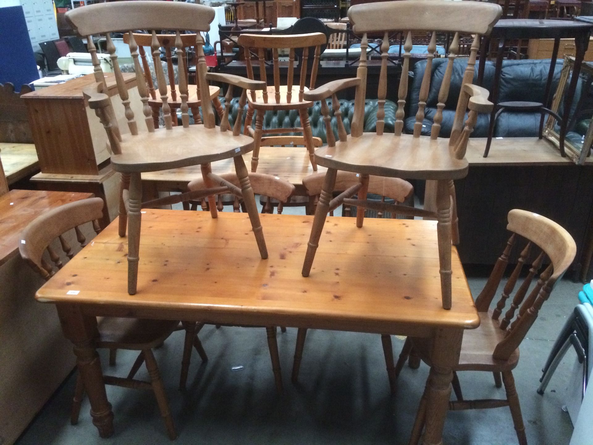 A pine kitchen table 153 x 77cm long complete with six pine kitchen chairs (two carvers)