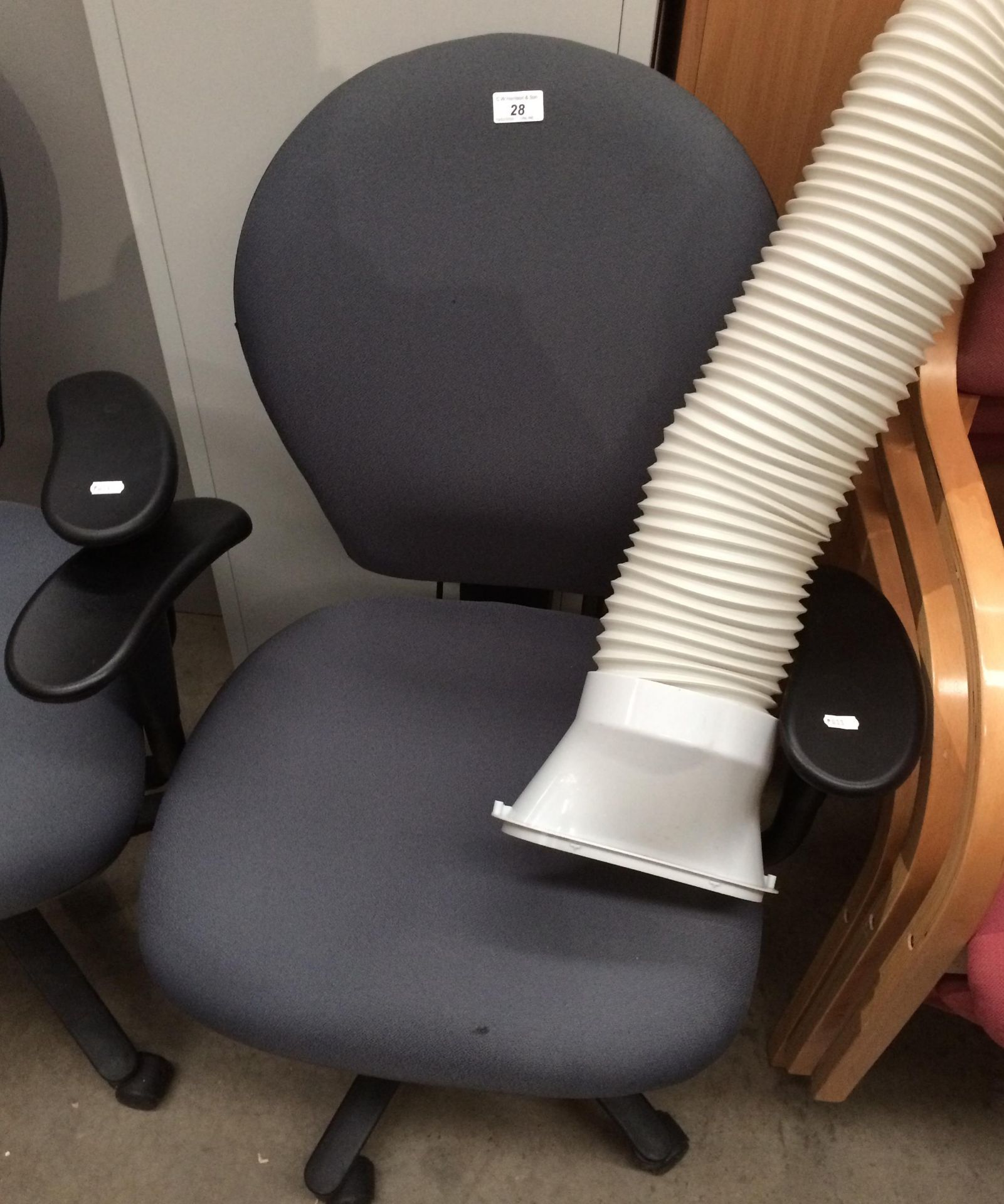 A grey upholstered office swivel armchair