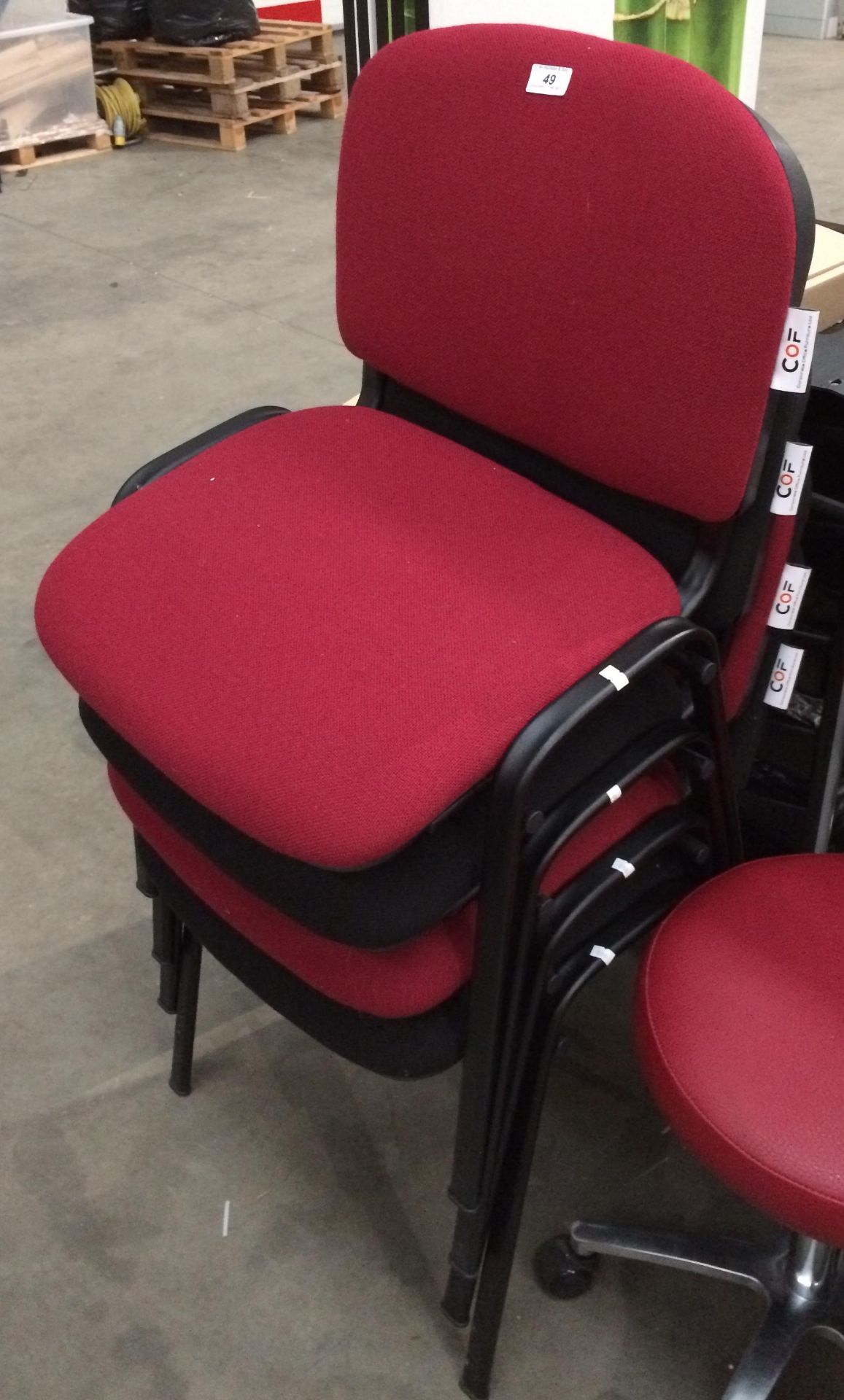 4 x red and black upholstered stacking chairs on black metal legs by COF