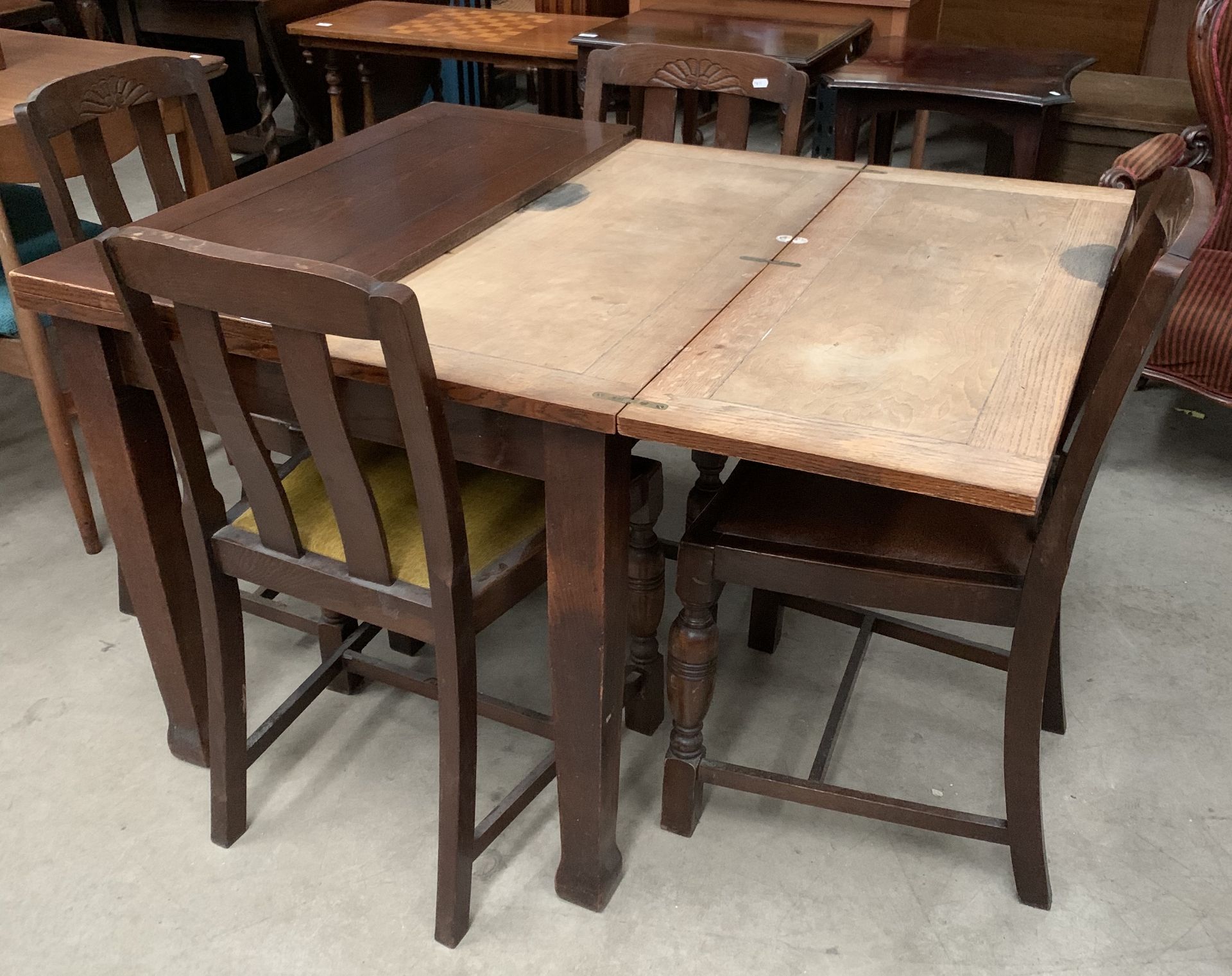 An oak lift top dining table on square tapered legs 92 x 144cm with open and four oak dining chairs