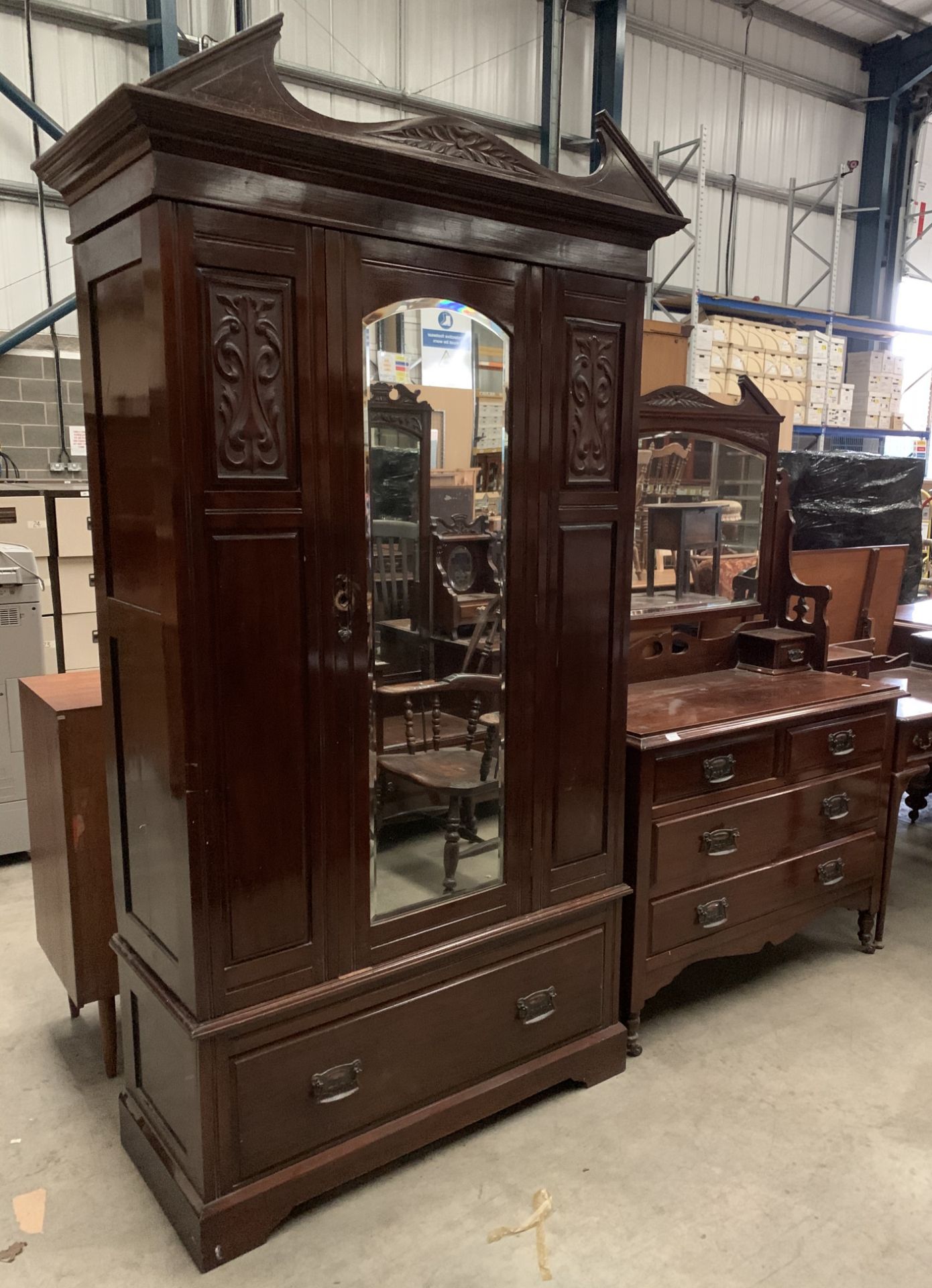 A mahogany two piece bedroom suite comprising wardrobe with centre mirror door and under drawer 106