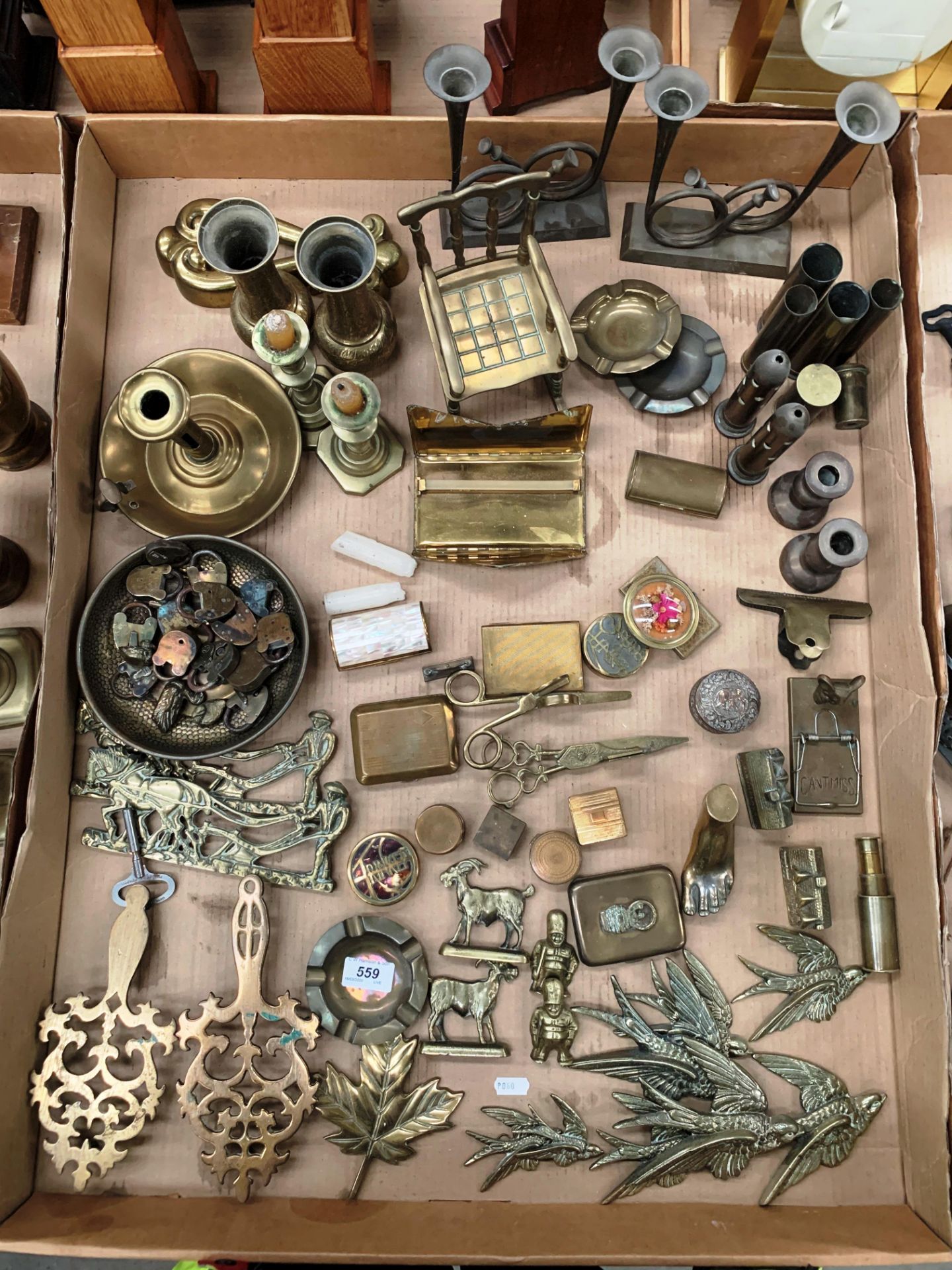 Contents to tray - a large collection of brassware candlesticks, candle snuffers,