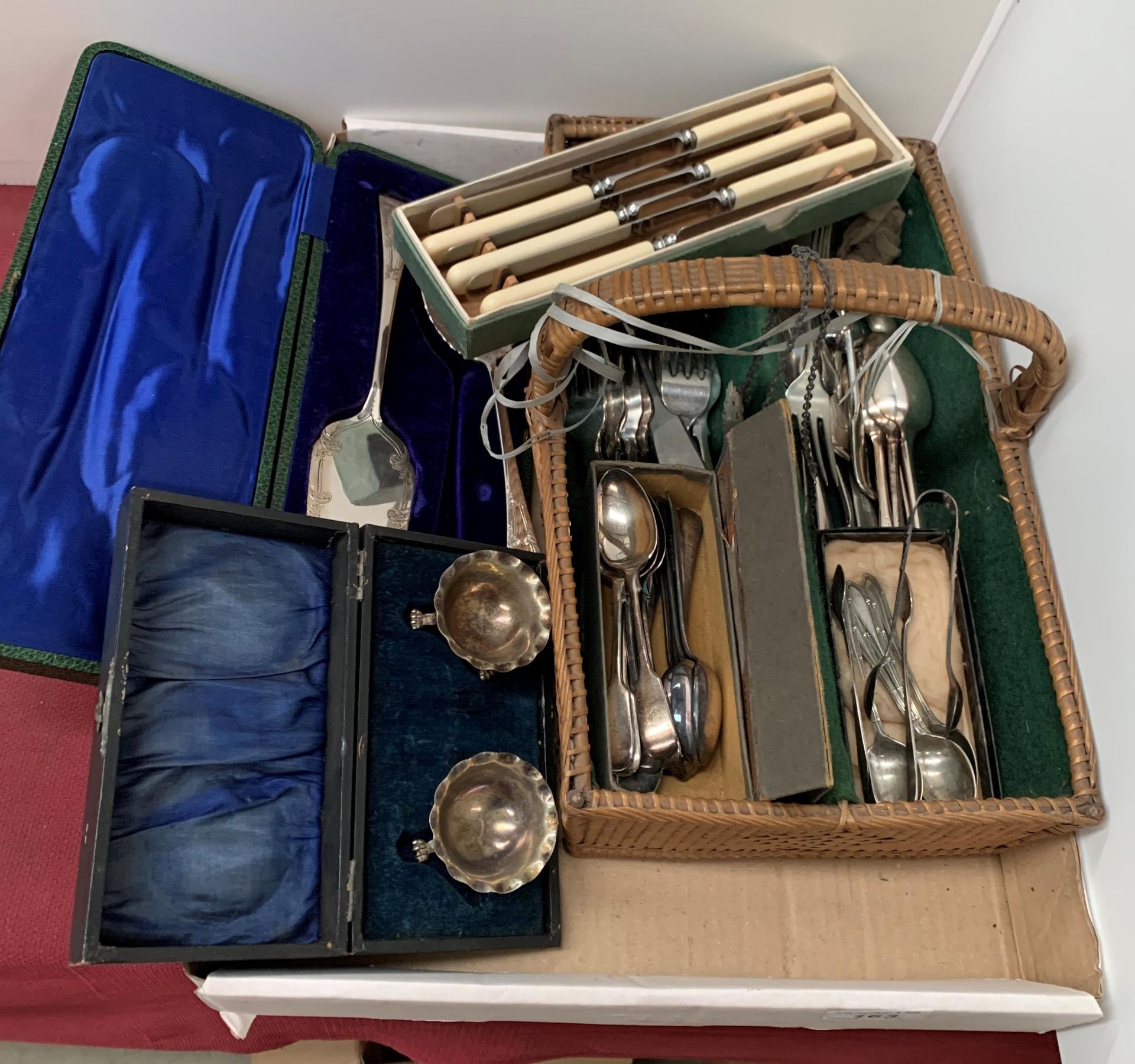 Contents to tray - plated cutlery, plated cake knife and spoon, pair of plated salts,