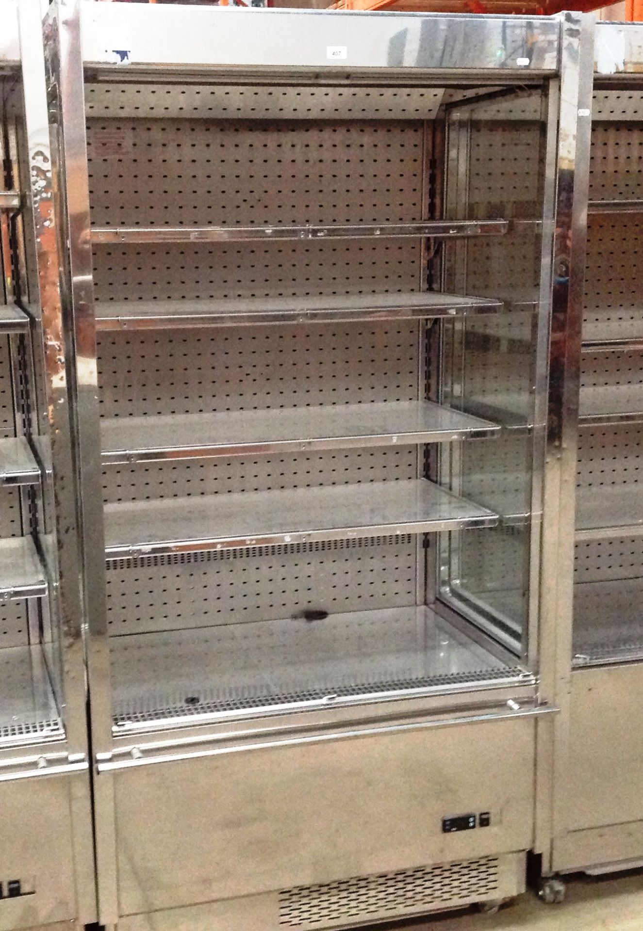 A stainless steel cased mobile chilled food display cabinet with shelves and roller front