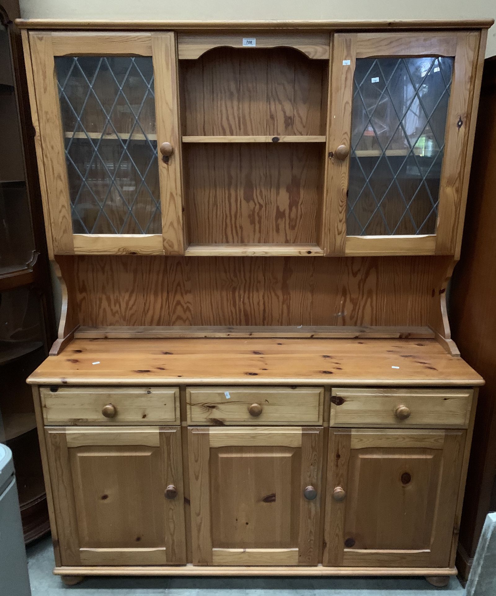 A pine dresser with two upper leaded glazed doors over three drawer three door base 138 x 180cm