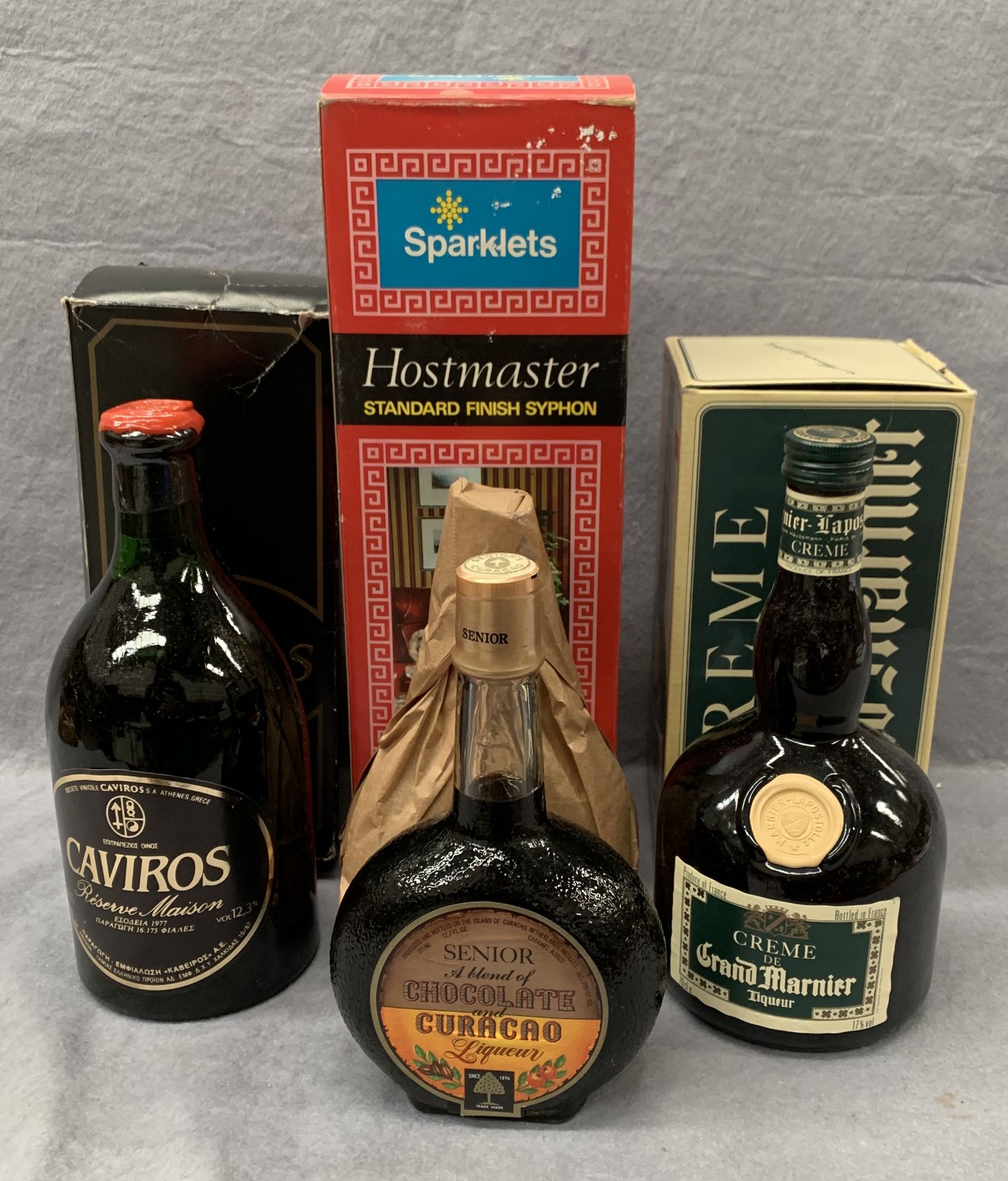 A 70cl bottle of Caviros, a 70cl bottle of Grand Marnier, two 12.