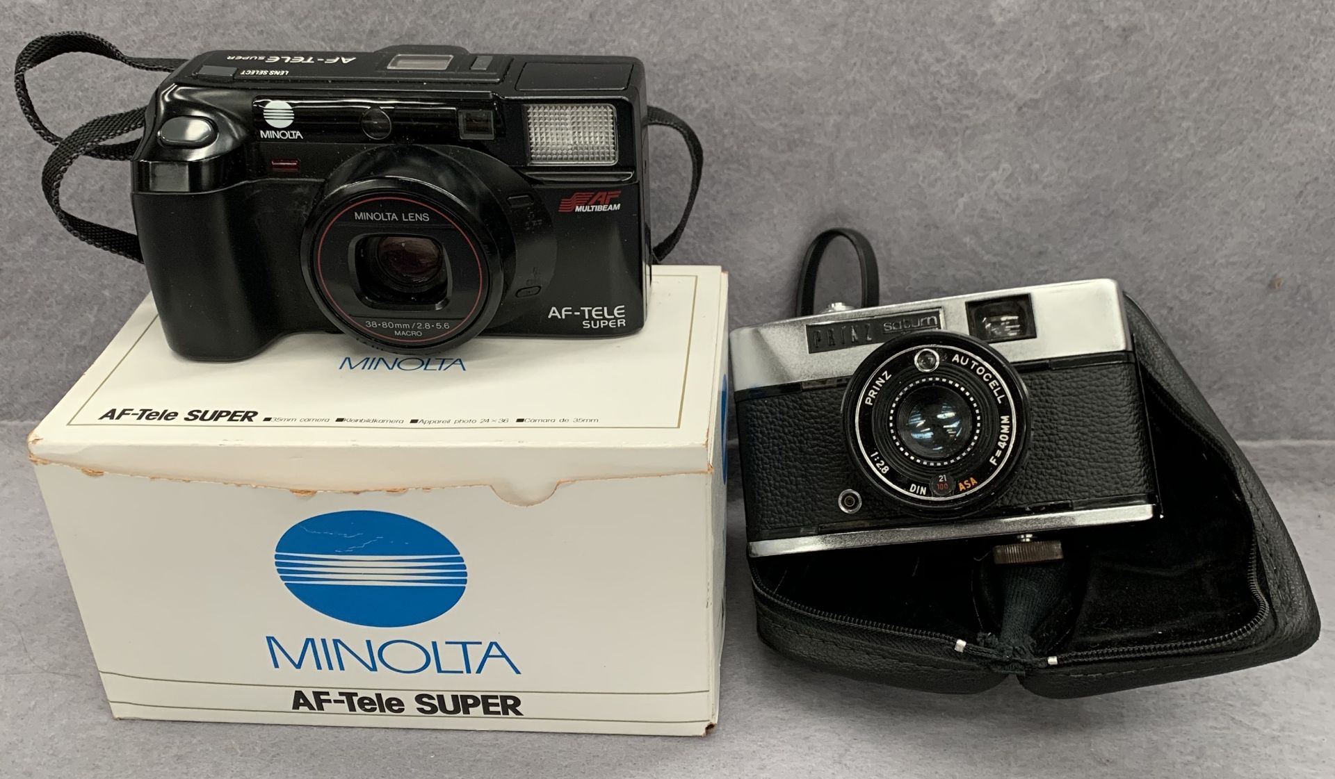 A Prinz Saturn 35 auto camera and a Minolta AF-Tele Super camera (boxed)