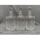 Three lead crystal decanters on glass tray (4)