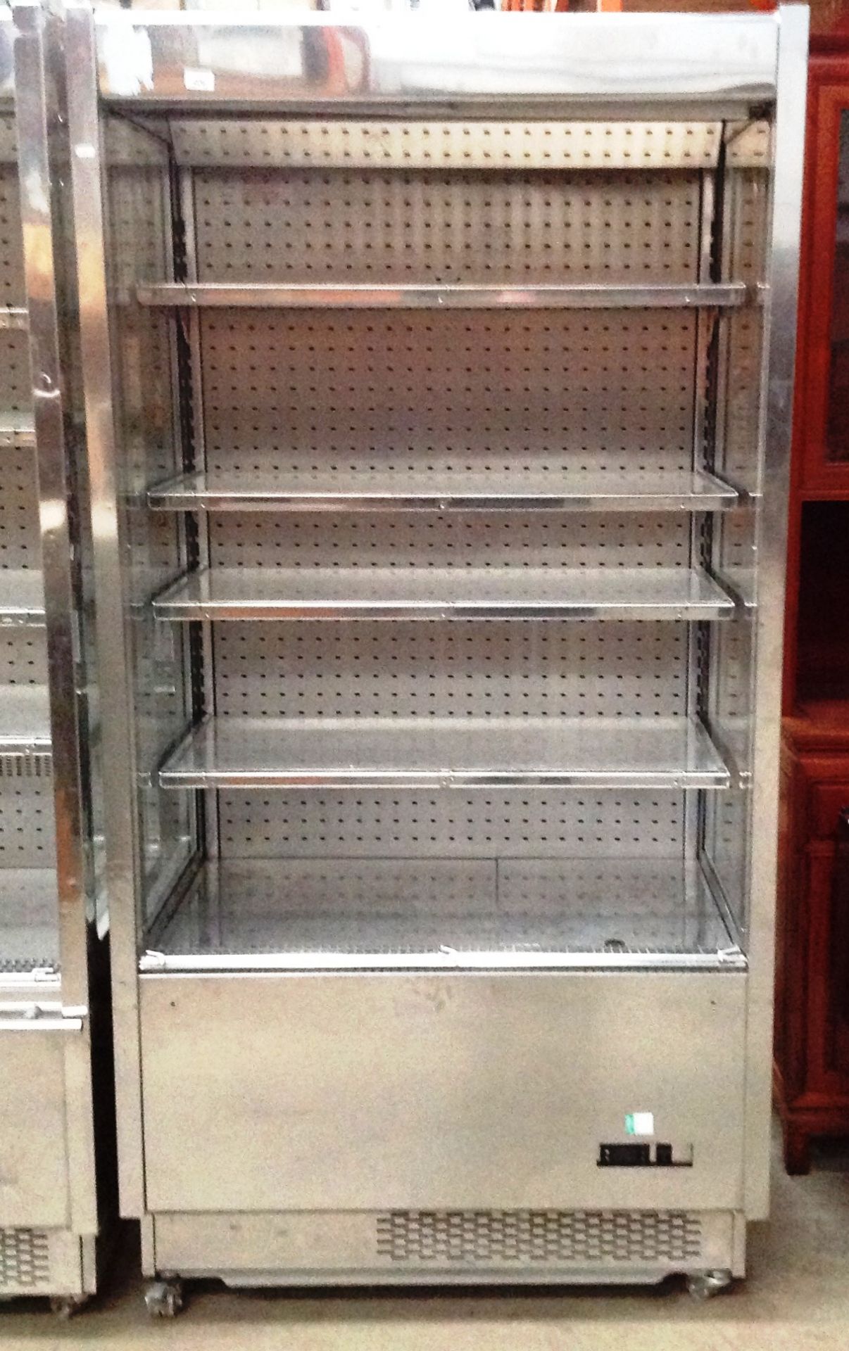 A stainless steel cased mobile chilled food display cabinet with shelves and roller front