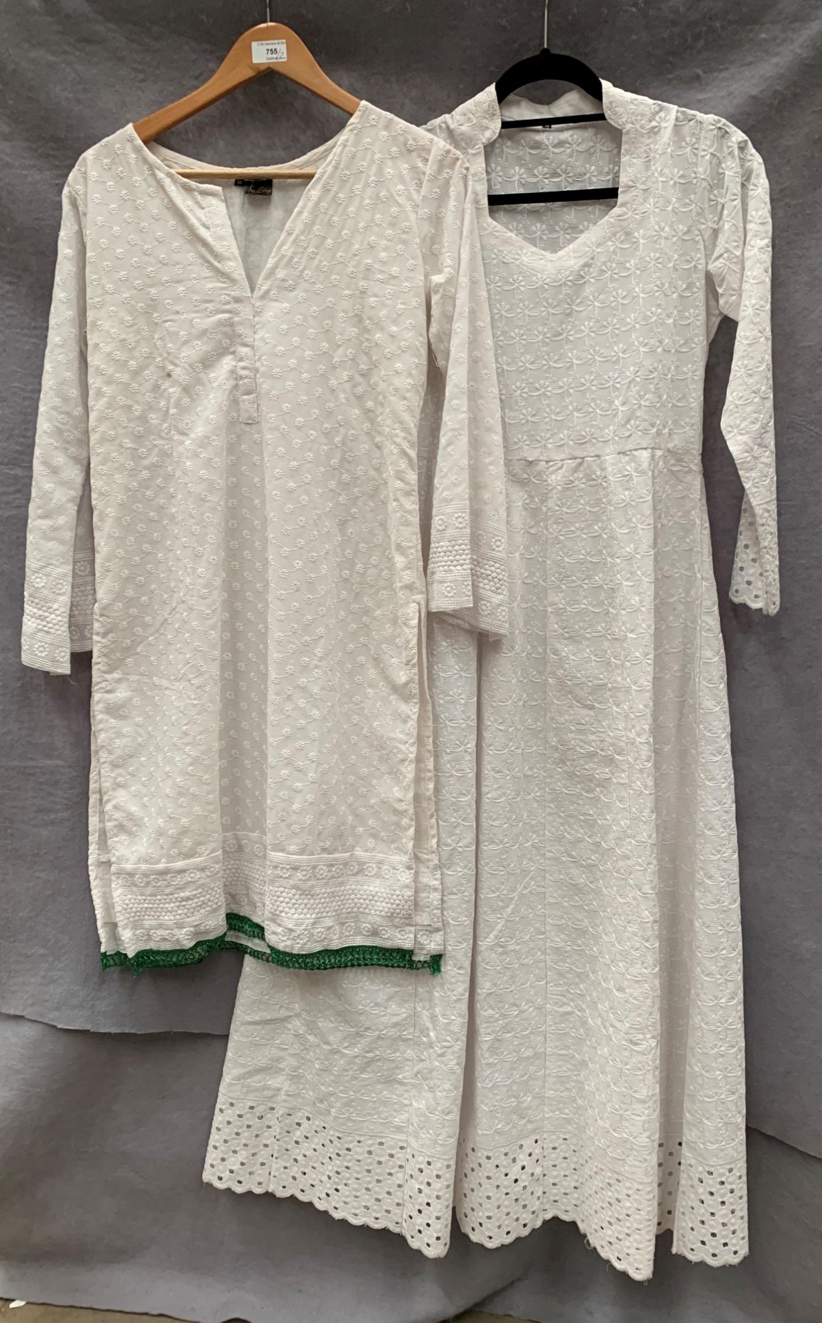 Two tunics (one short and one long) in white,
