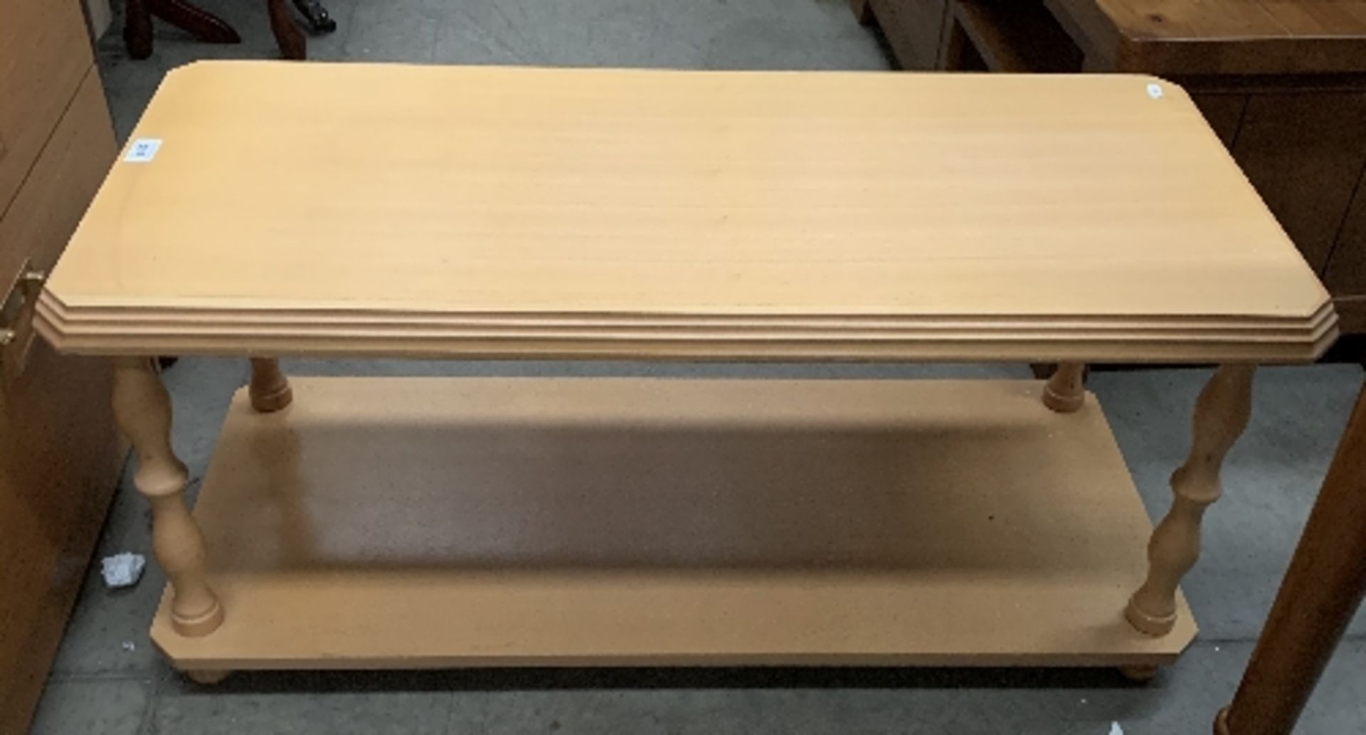 A light wood finish coffee table with under tray 96 x 42cm