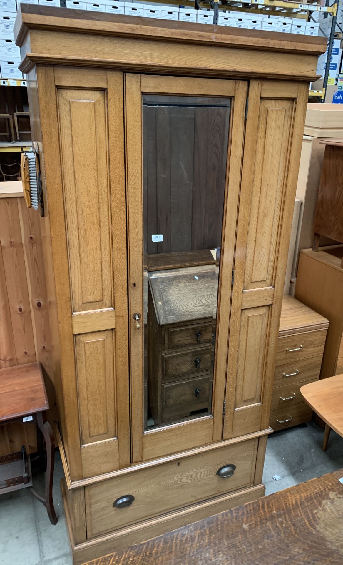 An oak single mirrored door wardrobe with underdrawer,