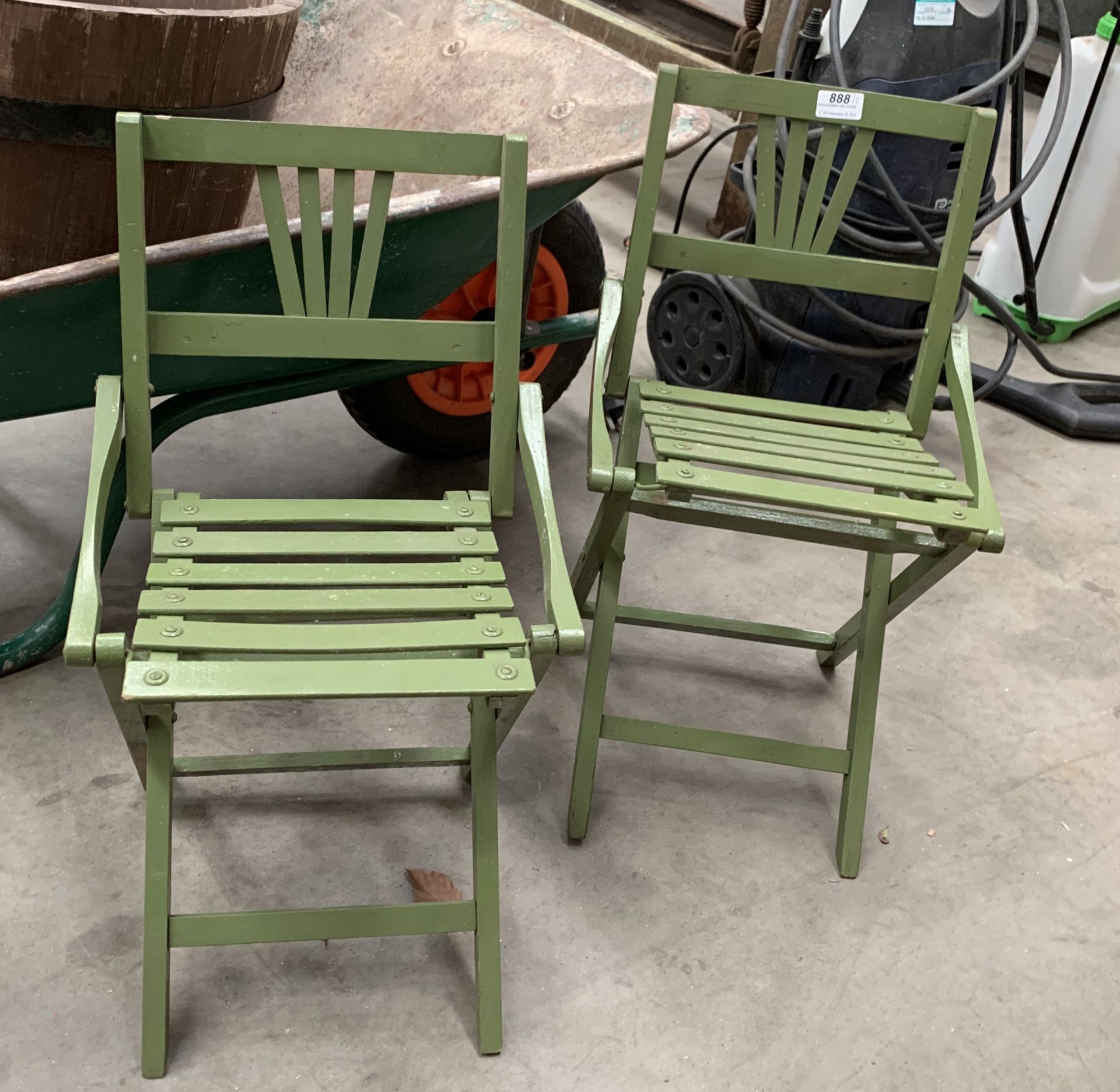 A pair of green painted wood framed children's folding garden chairs