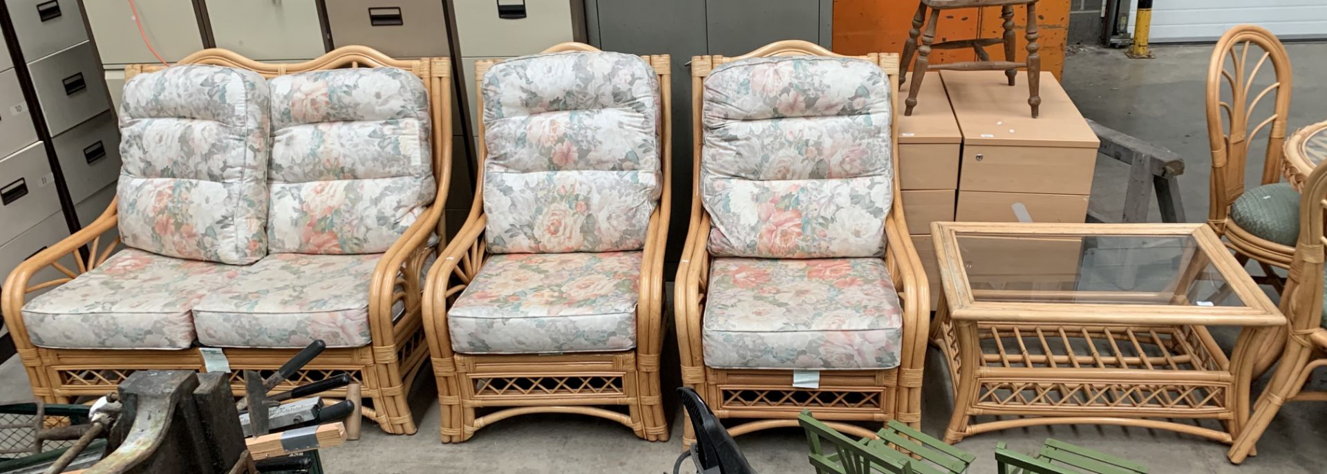 A bamboo framed four piece conservatory suite with floral patterned cushions,