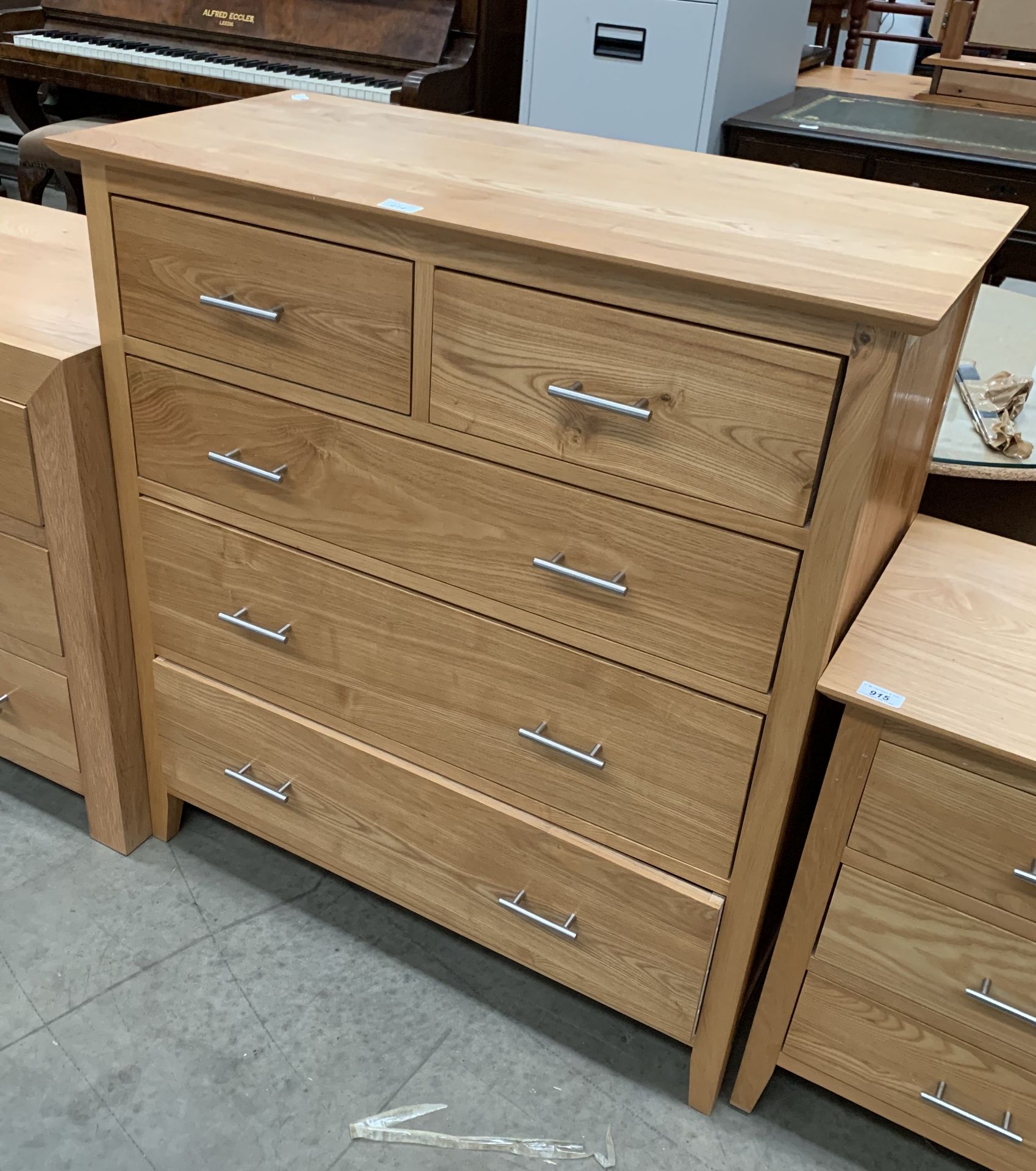 A light oak finish five drawer (two short, three long) chest of drawers,