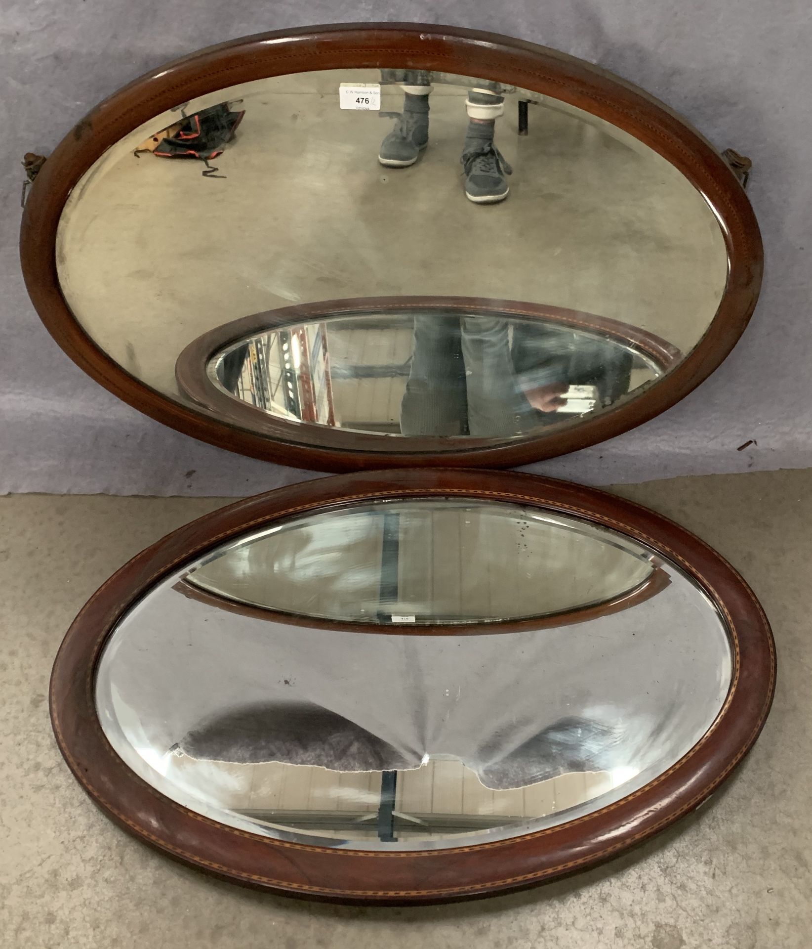 Two mahogany with line inlay framed oval wall mirrors,