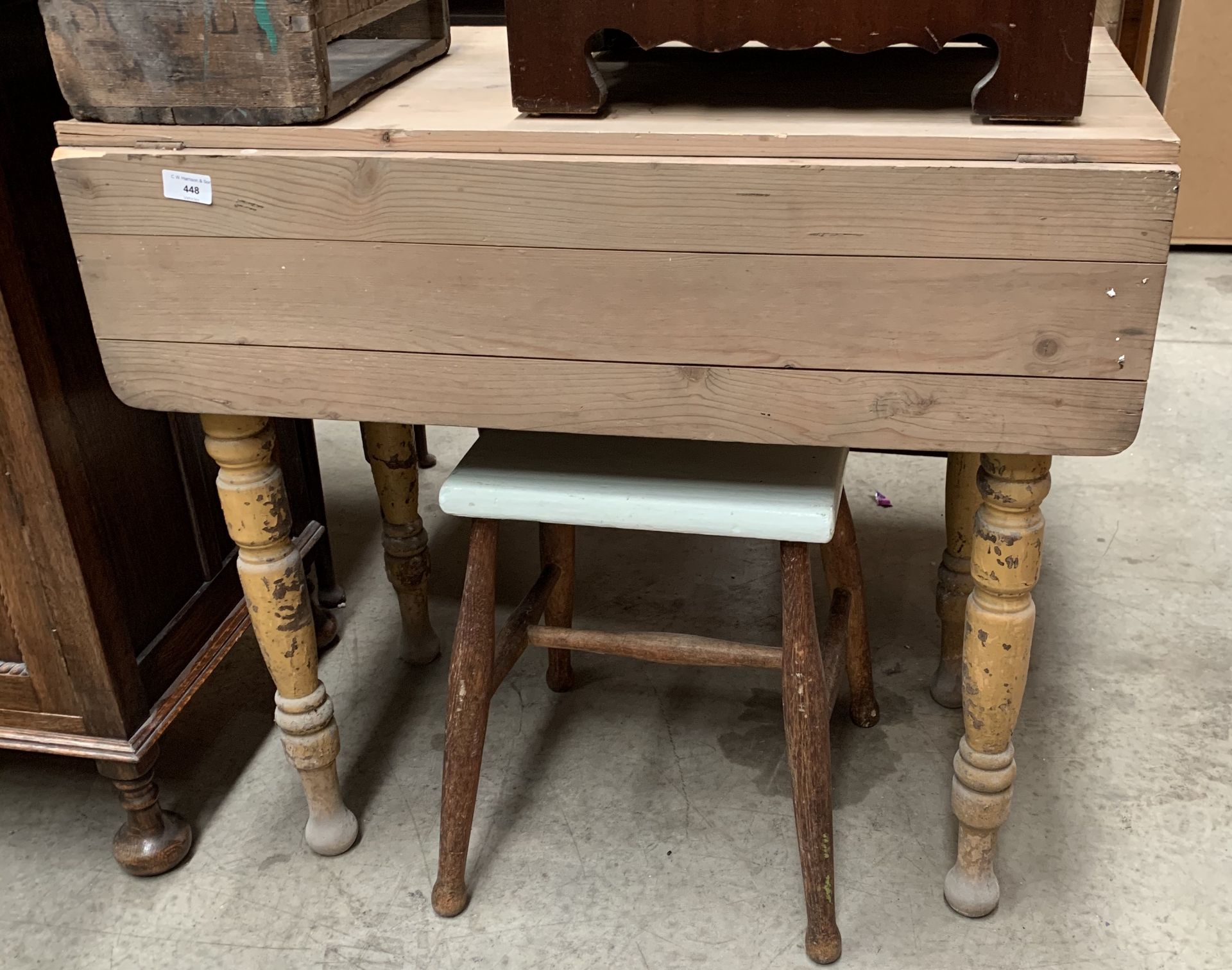 A small pine drop leaf kitchen table and a stool with painted seat (2)