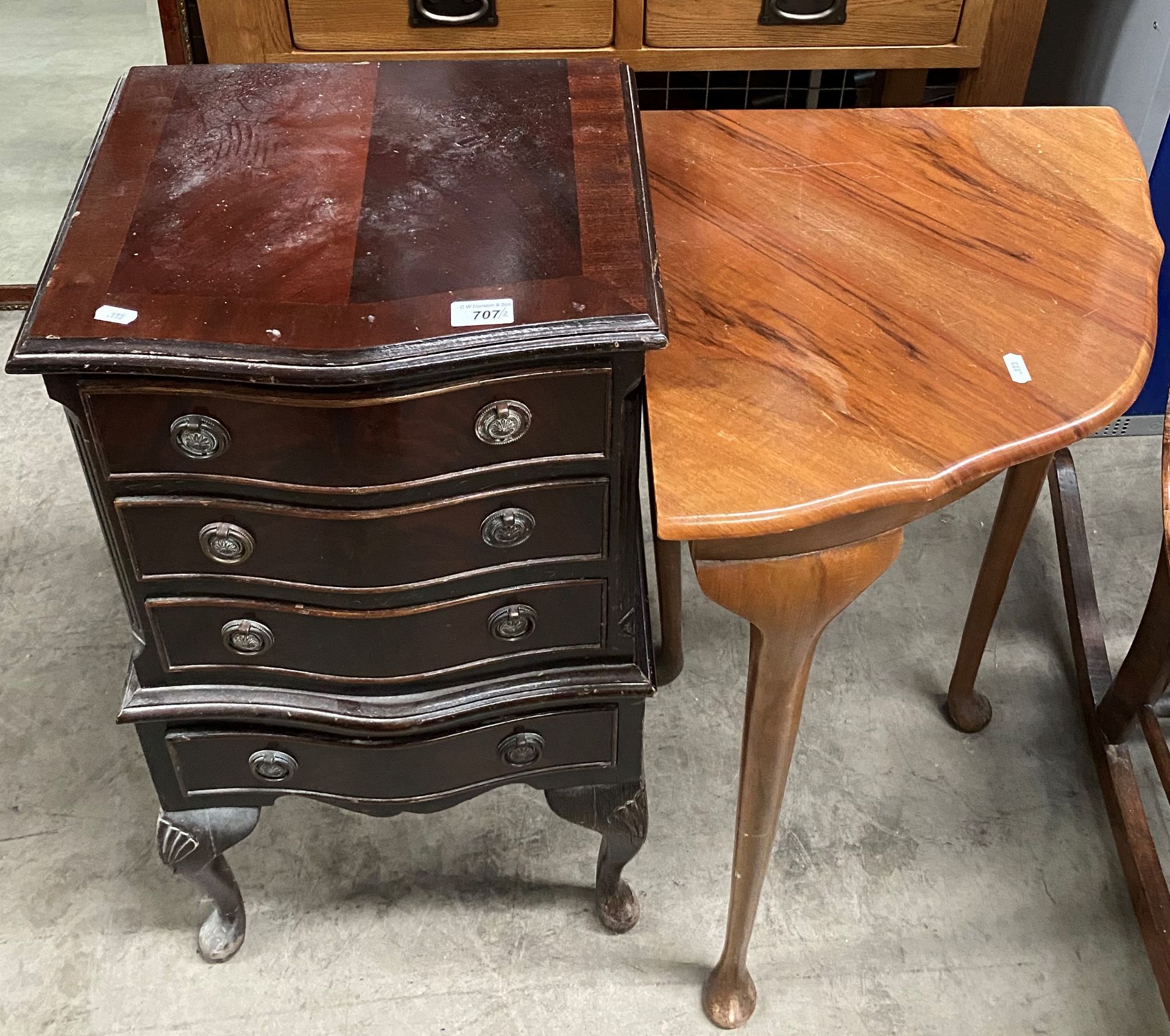 A mahogany reproduction bow front four drawer chest on cabriole legs,