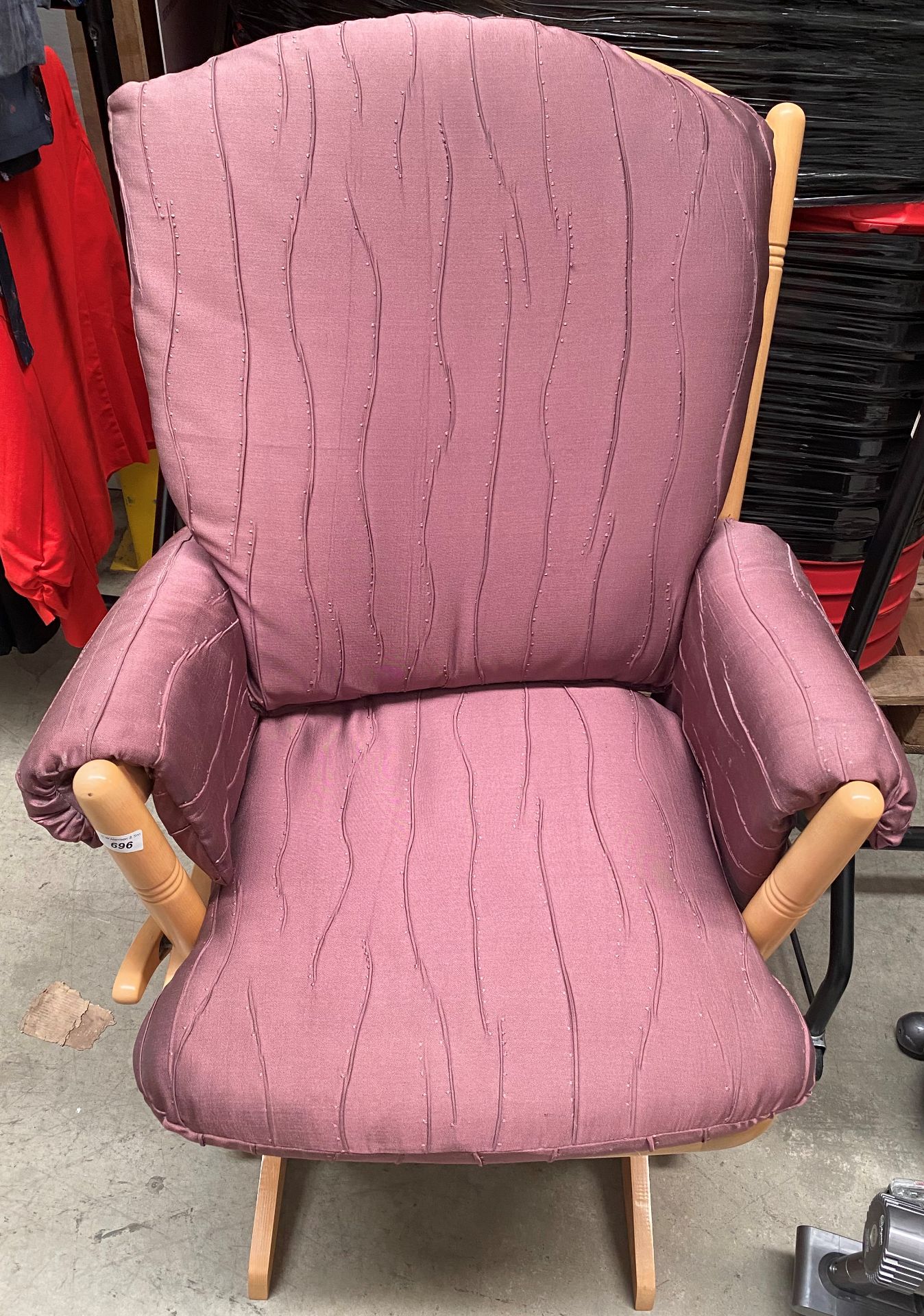 A Dutalier light wood framed rocker with dark pink upholstered seat and back