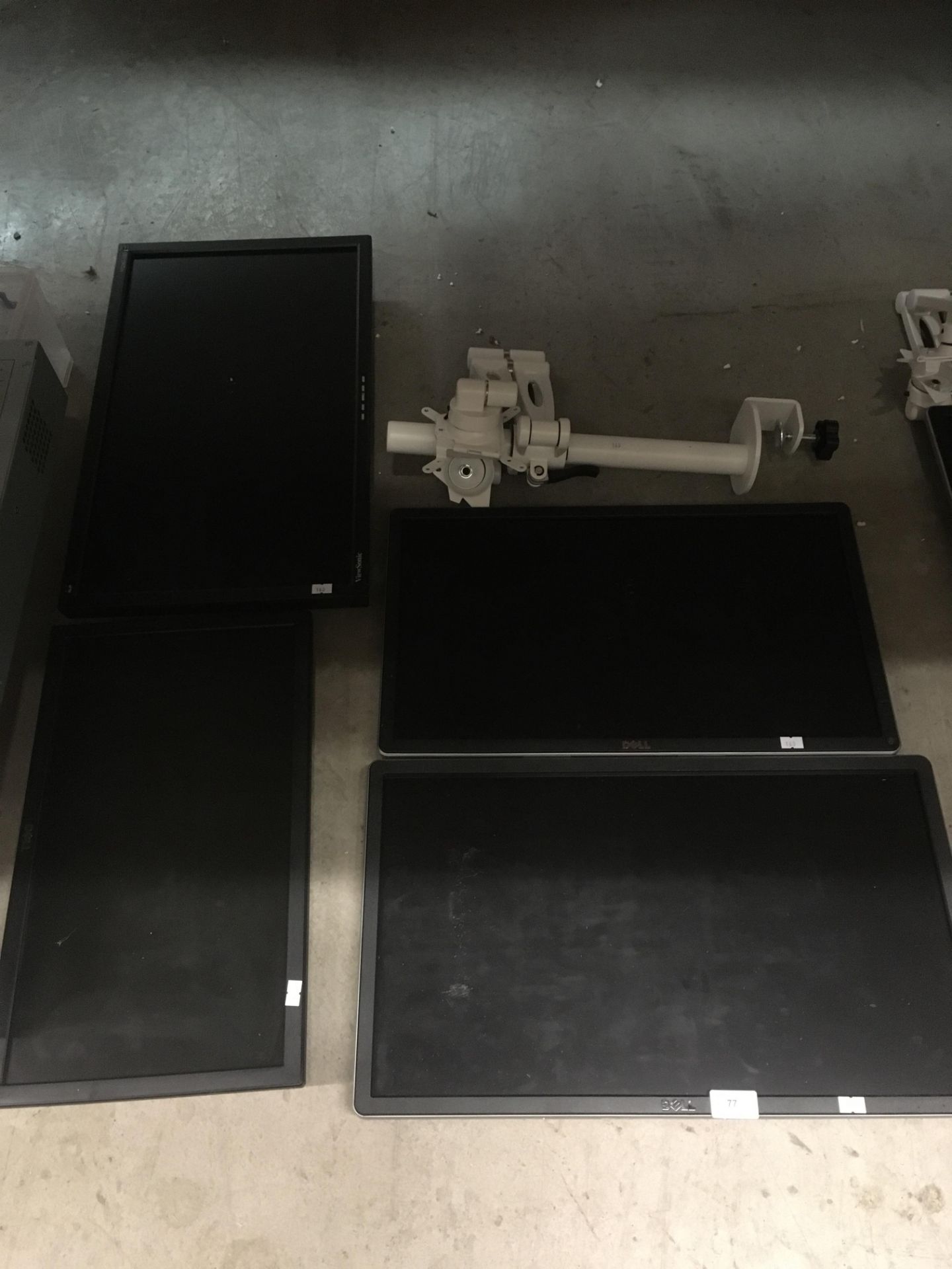 4 x assorted monitors by Dell and Viewsonic and two twin pole mounted monitor arms by Kardo