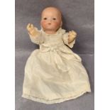 A bisque head baby doll marked AM 341/OK Germany,