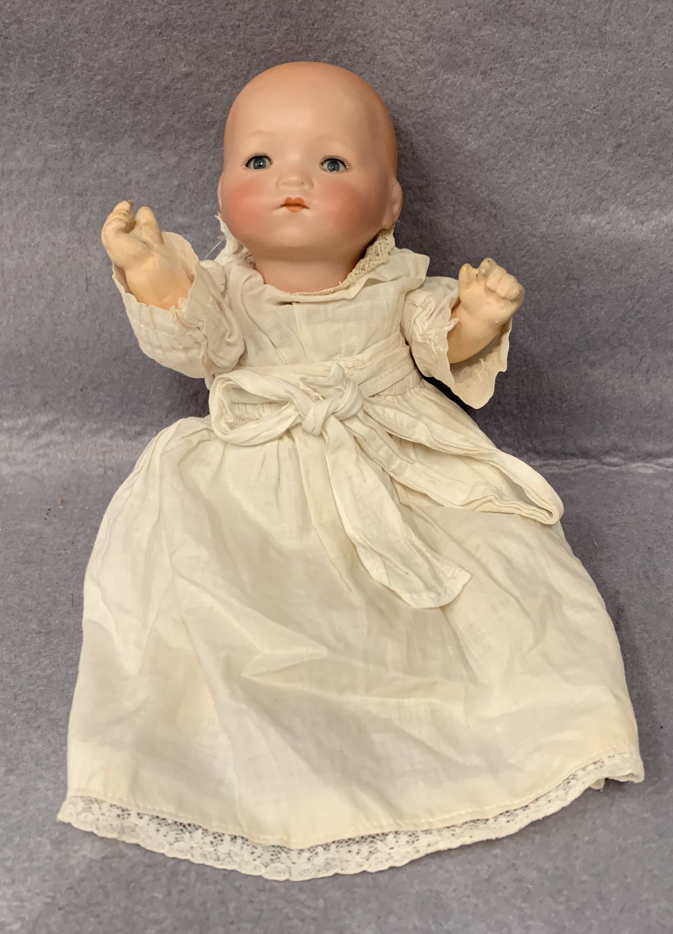 A bisque head baby doll marked AM 341/OK Germany,