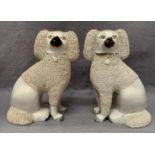 A pair of cream Staffordshire spaniels,