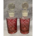 A small pair of cranberry decanters,