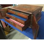 An oak and walnut finish three drawer table top specimen cabinet with front doors,