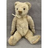 A beige soft toy teddy bear,