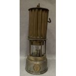 A brass and metal miner's lamp by The Premier Lamp Engineering Co.