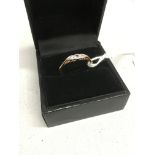 An 18ct gold and platinum three stone diamond ring total weight 2.