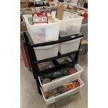 A black and clear plastic six tray modeller's storage unit and contents to four of the trays,