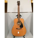 Yamaha F-340 six string acoustic guitar (missing one string) complete with folding stand