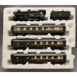 A Hornby OO gauge scale model train Cadbury Castle 7029 and three Pullman coaches in polystyrene
