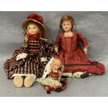 A collection of three small composition dolls, 9cm,