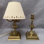An ornate brass candlestick, 26cm and a similar table lamp with shade,