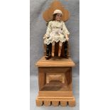 R H Lee, a German 250/70 bisque head doll mounted on a rocking chair with musical movement,