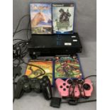 A Sony PlayStation 2, two controllers, two games,