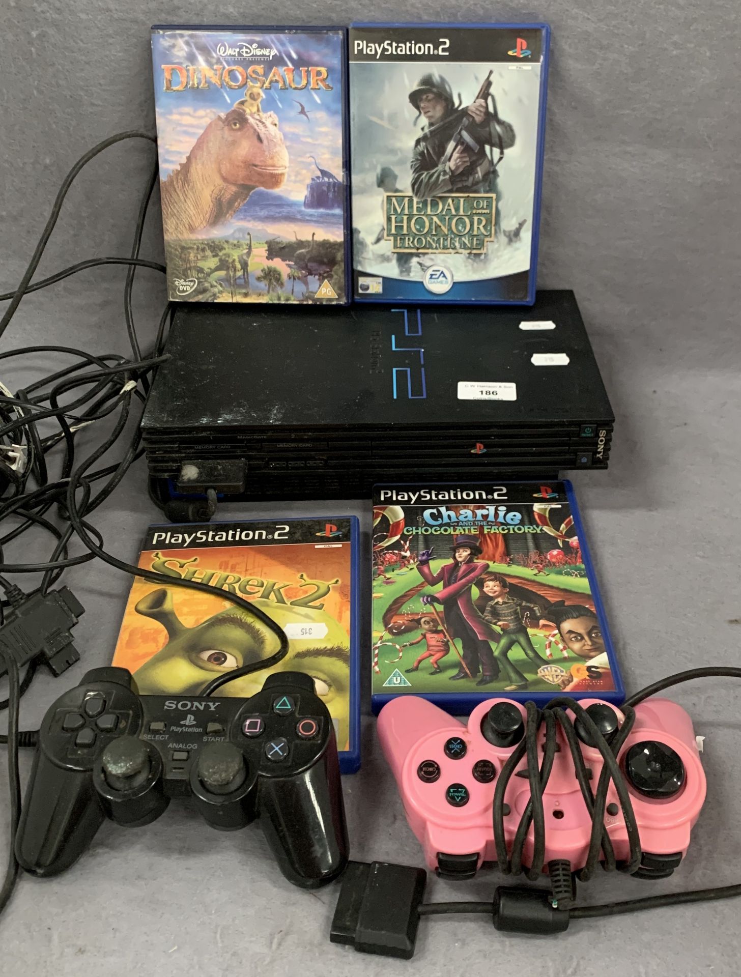 A Sony PlayStation 2, two controllers, two games,