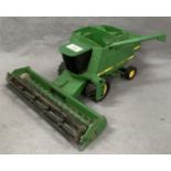 A scale diecast model of a John Deere 9500 combine harvester