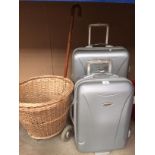 Two Constellation mobile suitcases (one medium and one small) and a mobile wicker shopping trolley