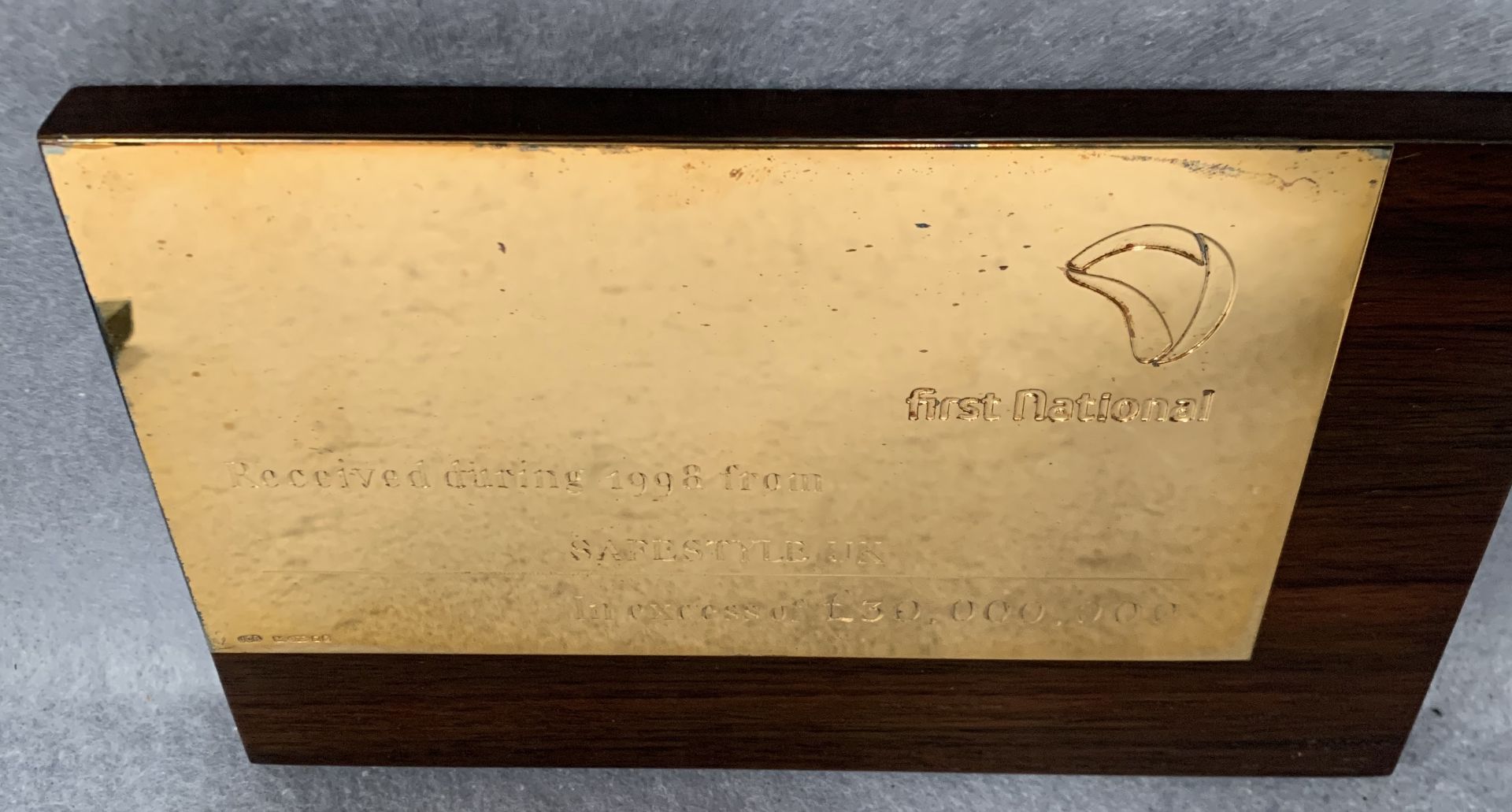 A silver presentation plaque from The First National Bank mounted on a walnut finish frame complete - Image 2 of 4