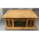 A table top record player/CD player and radio in light oak finish