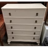 A cream painted five drawer chest of drawers,